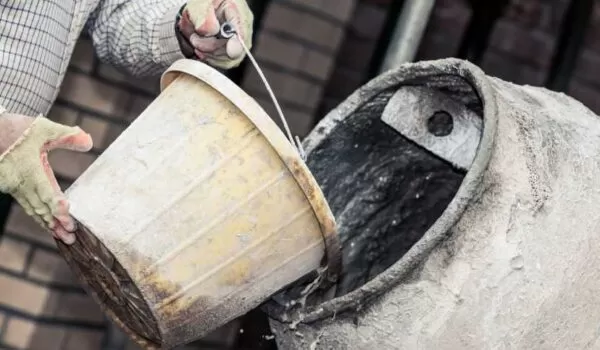 Cement being poured into a mixer | EasyMix Concrete 